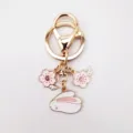 Cute alloy keychain featuring pink sakura cherry blossom and cute rabbit charms, detail view. - Lying Rabbit Cherry Blossom Style (2)
