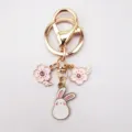 Cute alloy keychain featuring pink sakura crystal charms and a sweet white rabbit pendant. - Sitting Rabbit Cherry Blossom Style (3)