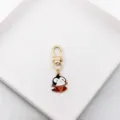 Close-up detail of the cute devil cartoon enamel keychain charm with gold clasp and ring. - Vampire Devil