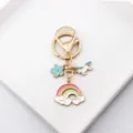 Detailed shot of cute unicorn rainbow metal keychain with colorful enamel charms for bags. - Style 1