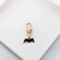 Close-up detail of the cute black bat pendant on a gold alloy keychain, perfect for bag charm. - Black Bat