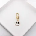 Close-up detail of cartoon skull alloy keychain charm and gold-tone clasp accessory. - Funny Skull Head