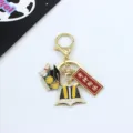 Detailed view of graduation metal keychain with doctoral cap, book charm and exam blessing plaque. - God of Exams