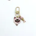 Detail view of the cute alloy siamese cat keychain pendant with pink fish bone. - Siamese Cat Style (3)