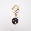 Close-up of alloy dripping oil keychain with cute moon rabbit and cloud pendant detail. - Rabbit on the Clouds