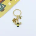 Honeybee keychain detail view featuring cute rhinestone enamel bees and honeycomb charm. - Honeycomb Bee Style (A Style)
