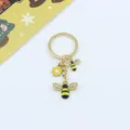 Detailed view of the cute bee alloy keychain with sparkling rhinestones and matching floral charm. - Double Bee Flower Style (C Style)