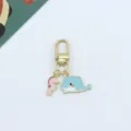 Detailed close-up of cute cartoon marine whale and pink seahorse metal keychain bag charm. - Little Whale