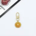 Orange slice metal keychain bag charm pendant detail view, cute fruit design accessory. - Orange Slice (5)