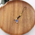 Starry astronaut phone charm detail shot, featuring black braided strap and cute space pendant. - Blue Starry Helmet Astronaut Style (2)