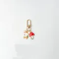 Detailed shot of a cute metal rabbit and mushroom keychain bag charm with gold clasp. - Rabbit Carrot Mushroom Pearl Style (3)
