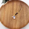 Cute astronaut and star phone charm bag pendant, stylish cosmic design detail close up. - White Enamel Astronaut Style (6)