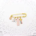 Close-up detail of a gold-plated inspirational exam blessing brooch with colorful enamel charms. - Pink - Success in Exams