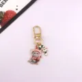 Close-up detail of the cute Christmas cat metal keychain charm with candy cane design. - Style 4