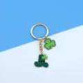 St. Patrick's Day metal keychain with green shamrock and leprechaun hat bag charm. - Three Leaf Clover and Hat Pendant