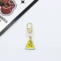 Detail view of a cute yellow watermelon slice alloy keychain charm, perfect for bags and keys. - Yellow Watermelon Slice (8)