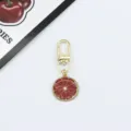 Gold-tone alloy metal keychain featuring a red citrus fruit slice pendant for bags. - Red Citrus Slice (9)