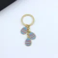 Cute Easter egg keychain with enamel blue charms, stylish metal keyring for women bag decor. - Blue Heart Wave