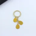 Close-up detail of the Easter egg metal keychain with yellow enamel and triangle patterns. - Yellow Triangle Pattern