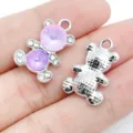 Close-up detail of silver alloy bear charms with pink crystal and rhinestone accents. - White K Purple Glass UV Rhinestone Bear (28430)