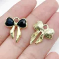 Detail view of alloy bow DIY jewelry pendants featuring black stone and gold textured finishes. - Black (Rhinestone Colorful)