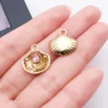 Close-up of gold shell charms with pink rhinestone and starfish for DIY jewelry making. - Marine Pink Rhinestone Shell (28173)