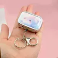 Metal pill box keychain with cute pink dolphin print, portable storage box detail view. - Dolphin Pill Box + Keychain + Lobster Clasp
