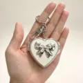 Silver heart mirror keychain with bow, cute ins style metal bag pendant and charm accessory. - Silver Bow
