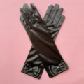 Detail view of black satin long gloves with elegant bows and shiny crystal rhinestones. - One Size / Black