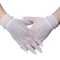 Detailed view of white fishnet mesh short gloves, delicate hollow design for stylish wear. - White