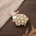 Detailed close-up of a charming sheep brooch decorated with pearls and sparkling crystals. - Gold Rhinestone Sheep Brooches