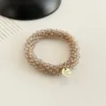 Koreanischer Kristallperlen Haargummi Armband doppelter Zweck elegantes Haaraccessoire - Champagnergold