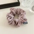 Shiny satin hair scrunchie detail shot, elegant pearl gloss fabric hair tie in mauve color. - Sweet Pink