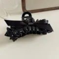 Close-up detail of black polka dot bow hair claw clip, elegant fabric hair accessory. - Shark Clips / Black Polka Dot Claw Clip