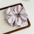 Close-up detail of Korean style minimalist piping design fabric hair scrunchie in light purple. - Purple