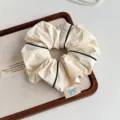 Korean minimalist fabric hair scrunchie with black piping detail for women and girls. - Off White
