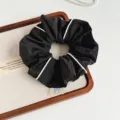 Korean minimalist piped fabric hair scrunchie close-up detail, elegant black with white edge. - Black