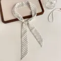 Detailed shot of Korean style polka dot hair scarf with elegant pearl buckle accessory. - Off White
