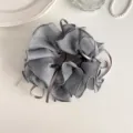 Detailed close-up of grey organza hair scrunchie featuring elegant fabric ribbon ties. - Gray