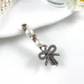 Crystal rhinestone bow hair clip pearl side clip sweet hair accessory for women detail view - Bow Style in Champagne