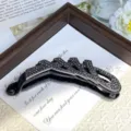 Detailed view of a luxury black rhinestone banana clip, modern geometric design for chic ponytail. - Style B with Black Base & Glossy Black