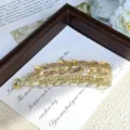 Close-up of elegant crystal leaf banana hair clip, sparkling rhinestones on golden frame detail. - Wheat Ear Champagne