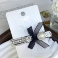 Sweet rhinestone pearl hair clip with black bow, elegant side clip for cute daily hairstyles. - Crescent Style in White Gold with White Rhinestones