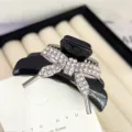 Elegant black bow hair claw clip with sparkling rhinestones, perfect for charming daily hairstyles. - Alloy Bowknot with White Rhinestones / Black