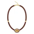 Close up view of brown braided cord necklace with gold metal parts and large oval yellow stone. - Dark Brown Rope Oval Zirconia Necklace