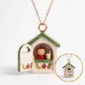 Detail view of the openable little house pendant necklace with cute juice bar interior. - Green House (Juice Shop)