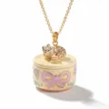 Close-up of a cute sleeping cat and miniature cake pendant necklace with enamel bow design. - Purple Bow Cat and Cake Locket Necklace