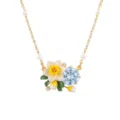 Close-up detail view of gold chain necklace featuring pearl accents, enamel daffodil and blue crystal. - March Birth Flower