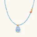 Close up view of the blue beaded necklace featuring a cute fish pendant and gold pineapple charm - Blue Fish Necklace / Blue