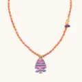 Detail shot of colorful beaded fashion necklace featuring a purple fish pendant and gold accents. - Purple Fish Necklaces / Purple